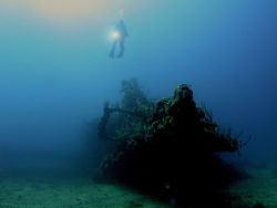 Diver hovers over the bow of the Wreck of the RMS Rhone by Terry Moore 
